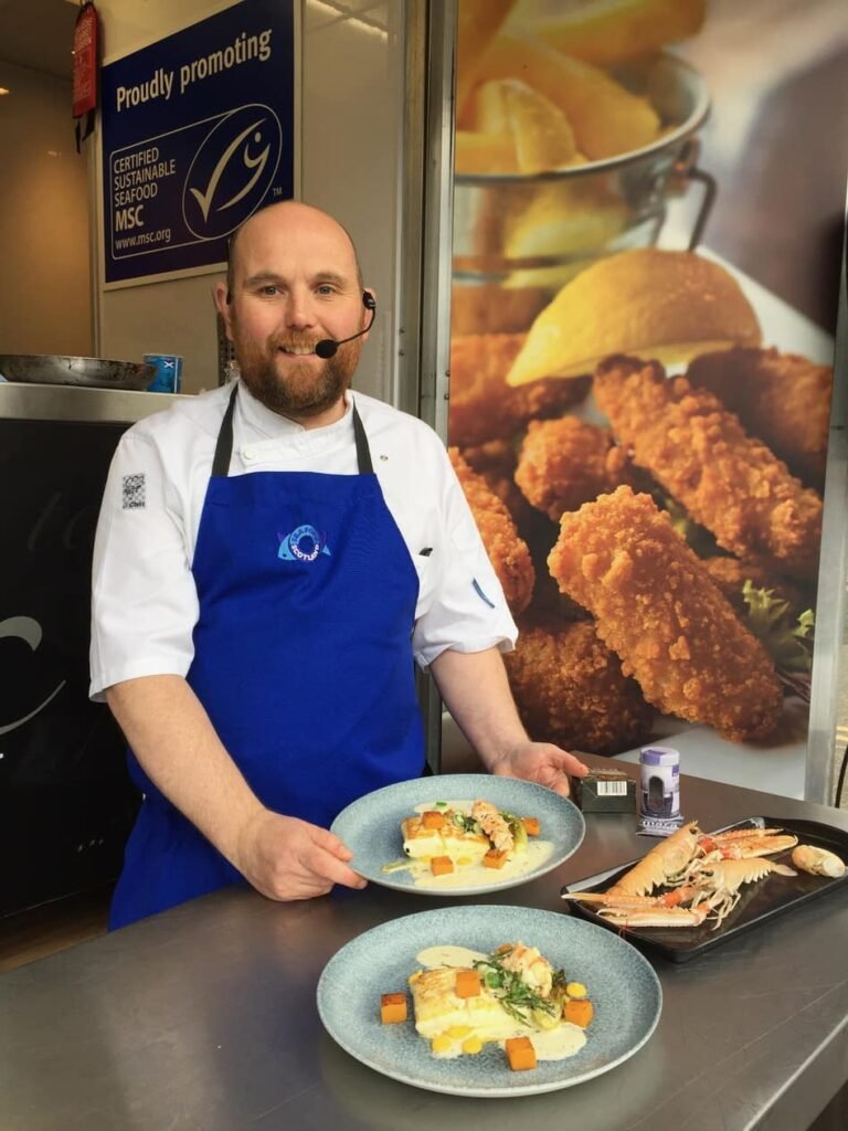 Kenny Smart plating up a seafood dish-min