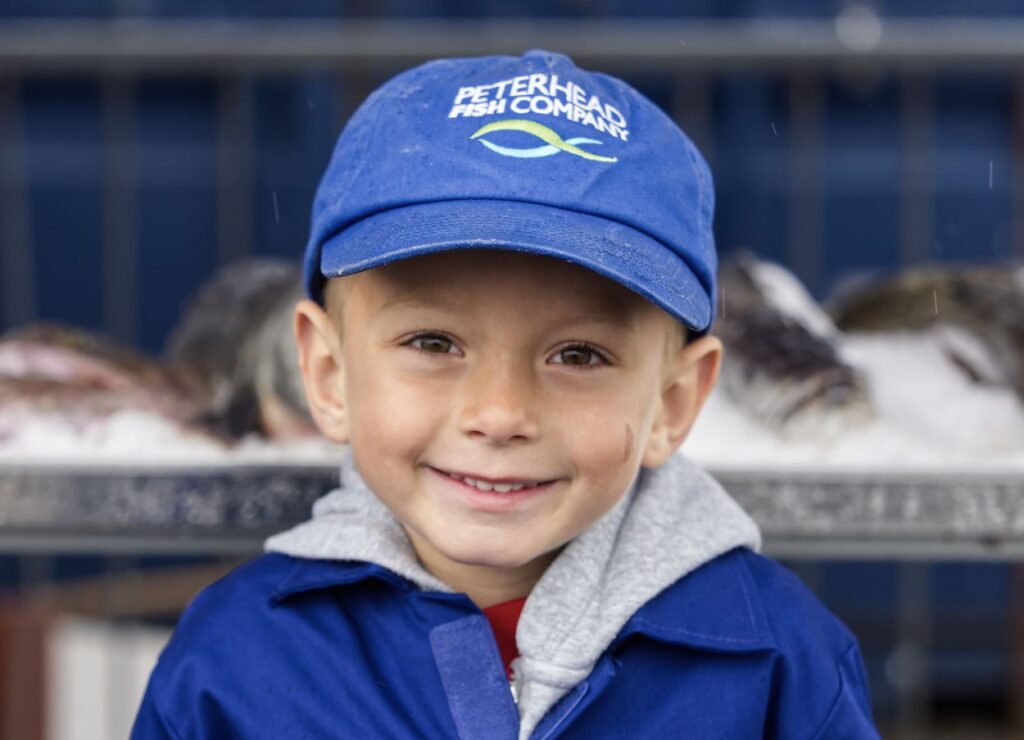 One of the youngsters lending a helping hand at Peterhead Fish Company. Credit - Fat Man Skinny Camera